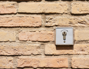 Silver wall mounted lock on a light brick wall